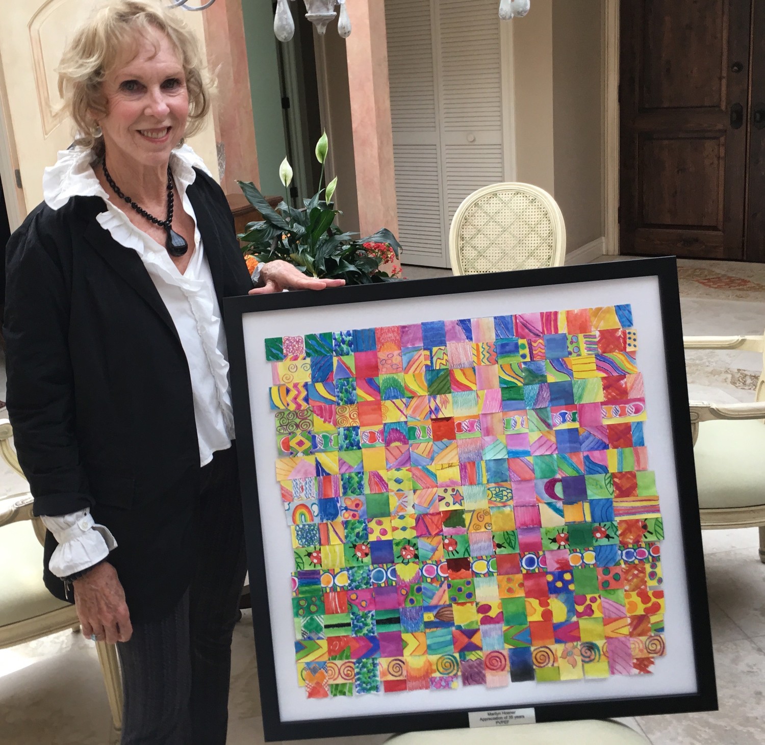 Marilyn Hoener poses with “The Thank You Art” artwork created by Ocean Palms Elementary students that was given to Hoener to thank her for 35 years of service with PVPEF.